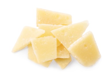 Pile of parmesan cheese pieces on white background, top view