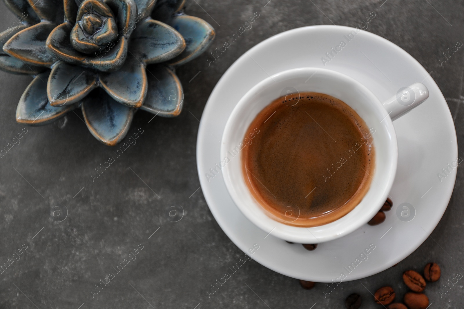 Photo of Cup of fresh aromatic coffee on table, top view