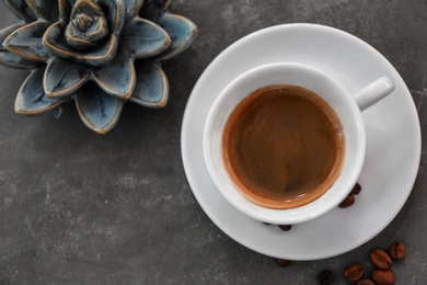 Cup of fresh aromatic coffee on table, top view