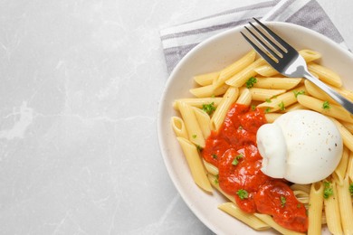 Photo of Delicious pasta with burrata cheese and sauce on light grey table, top view. Space for text