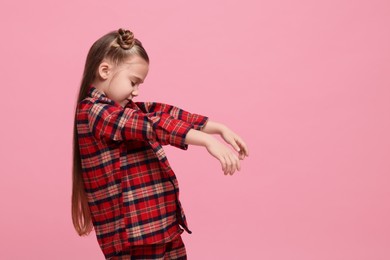 Photo of Girl in pajamas sleepwalking on pink background, space for text