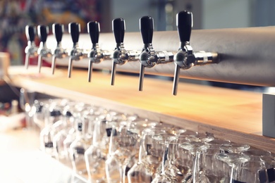 Photo of Row of shiny beer taps in pub
