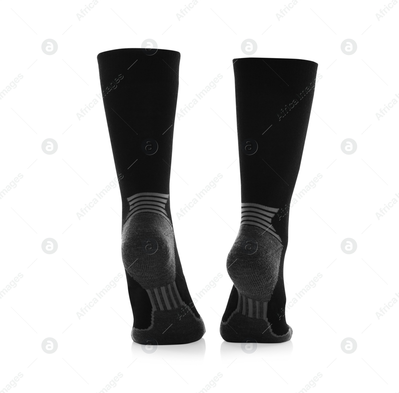 Photo of Woman wearing thermal socks on white background, closeup of legs. Winter sport clothes