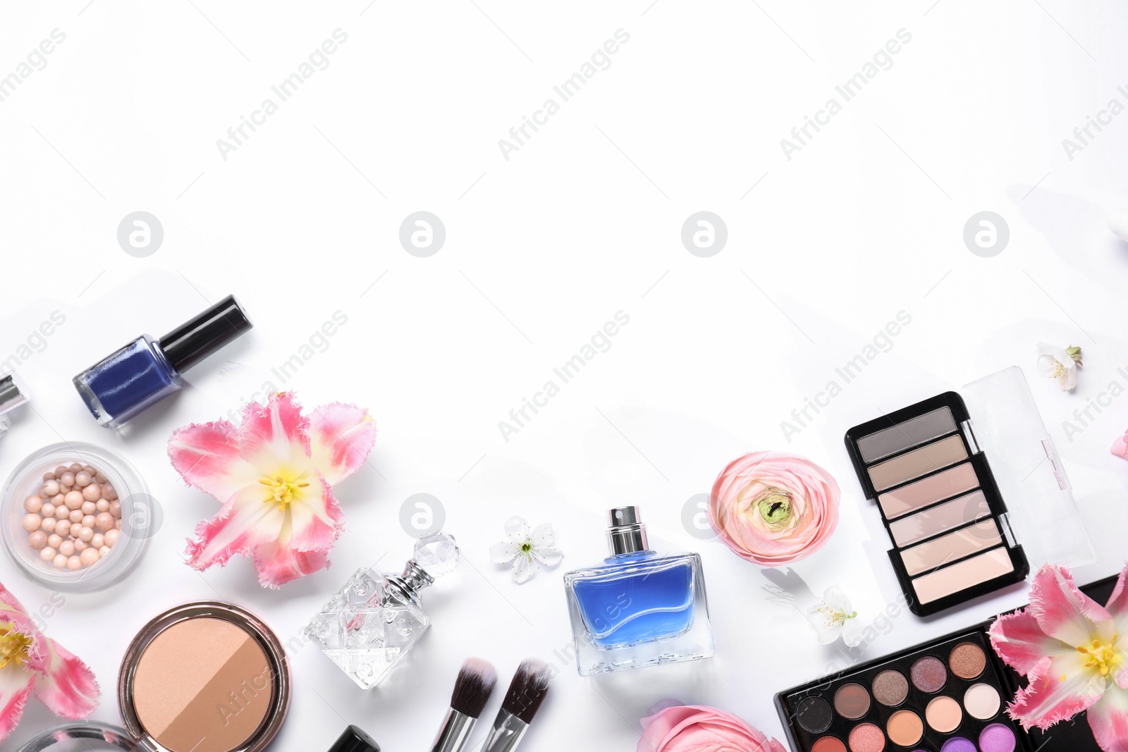 Photo of Flat lay composition with different makeup products and beautiful spring flowers on white background, space for text