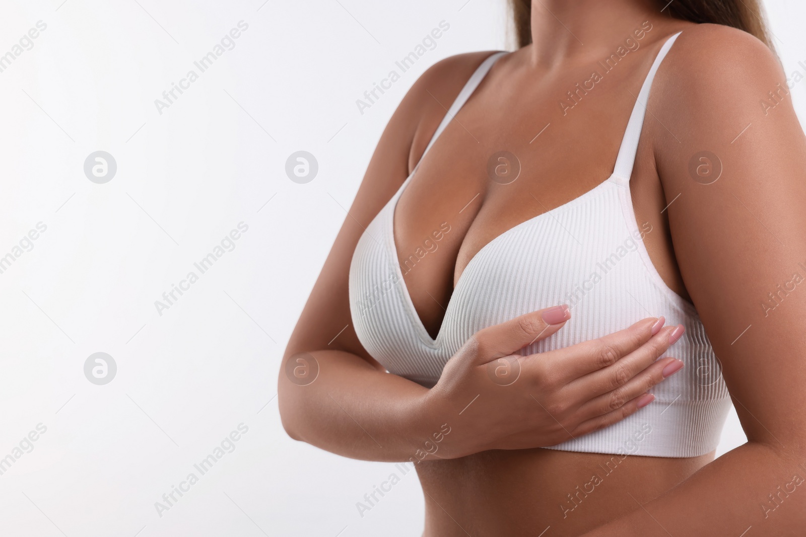 Photo of Woman with beautiful breast on white background, closeup. Space for text