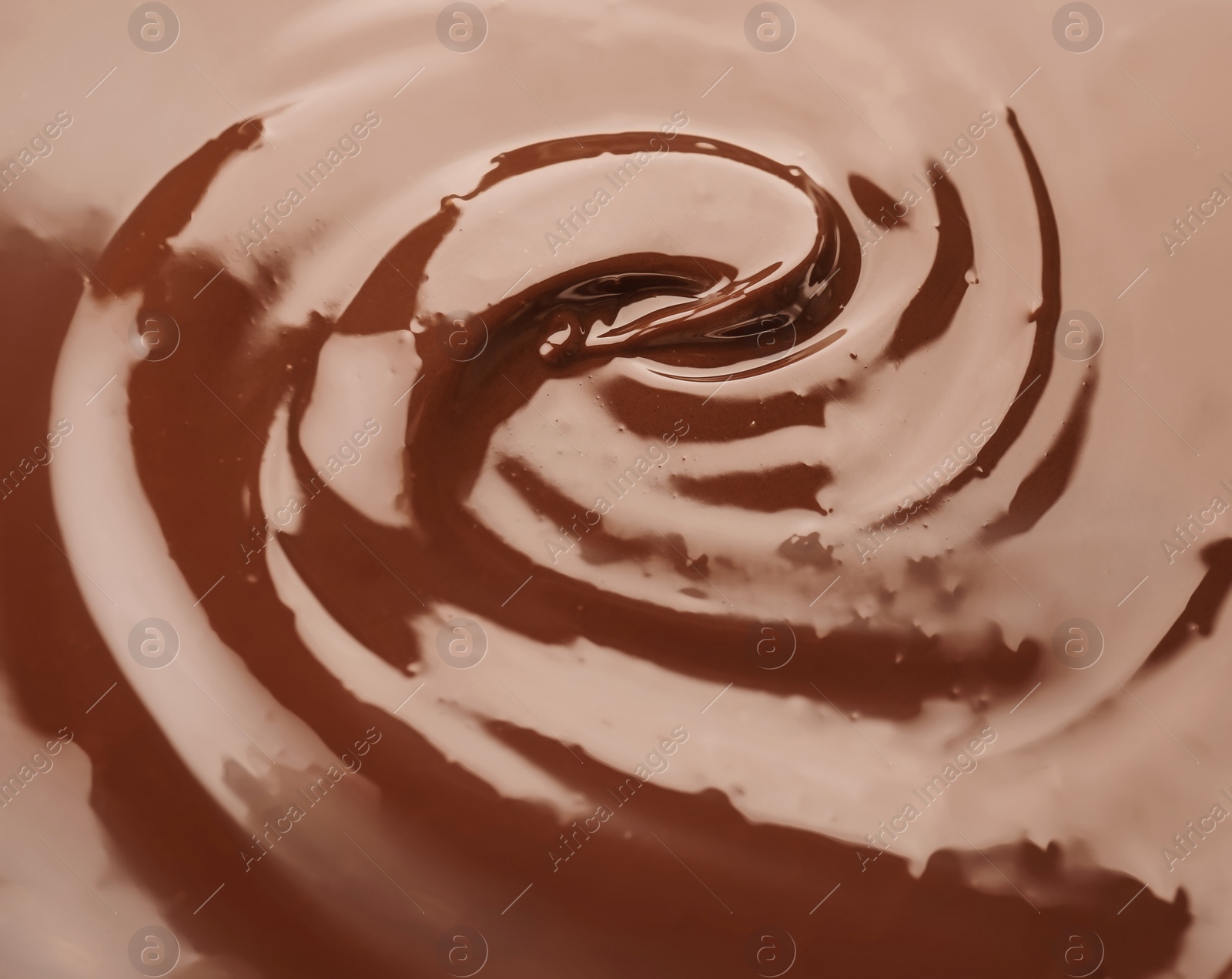 Photo of Delicious melted milk chocolate, closeup