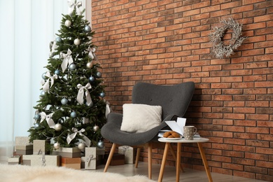 Stylish living room interior with decorated Christmas tree