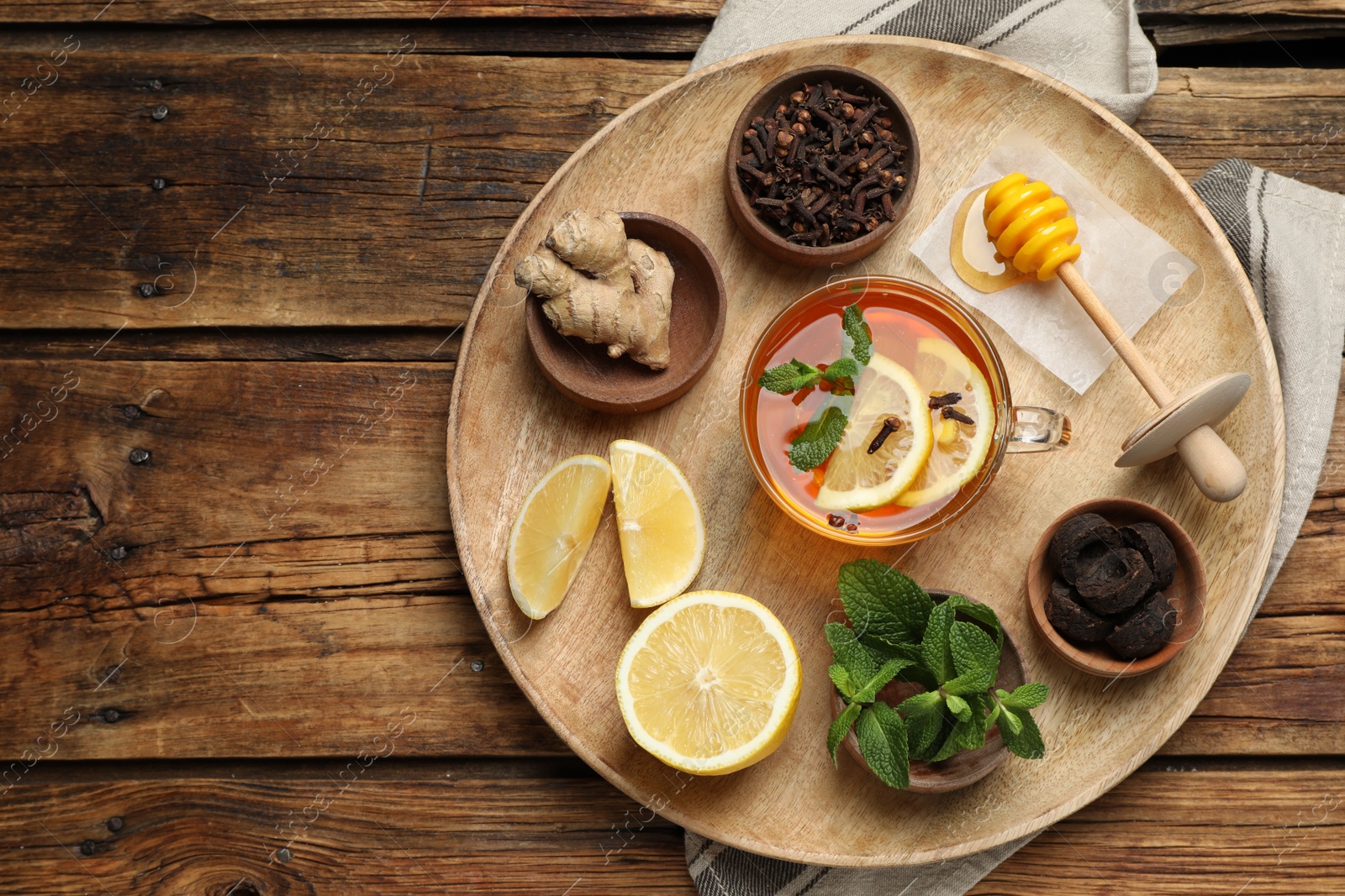 Photo of Tray with immunity boosting drink and ingredients on wooden table, top view. Space for text