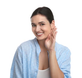 Photo of Young woman showing hand to ear gesture on white background