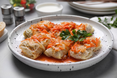 Photo of Delicious cabbage rolls served on grey table, closeup