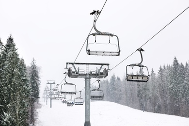 Photo of Ski lift at mountain resort. Winter vacation