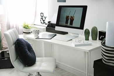 Comfortable workplace with computer on desk in home office