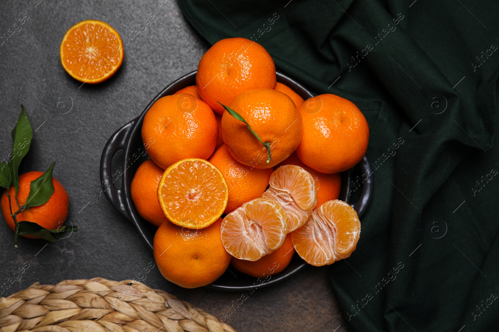 Photo of Fresh juicy tangerines on black table, flat lay