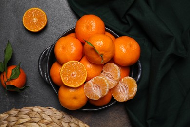 Fresh juicy tangerines on black table, flat lay