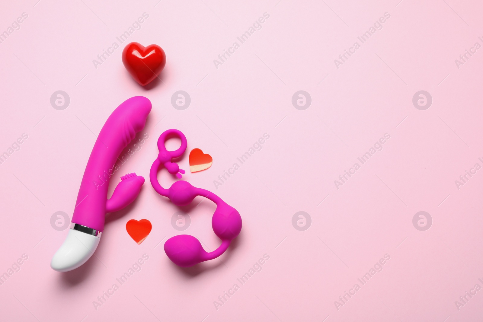 Photo of Flat lay composition with sex toys on pink background. Space for text