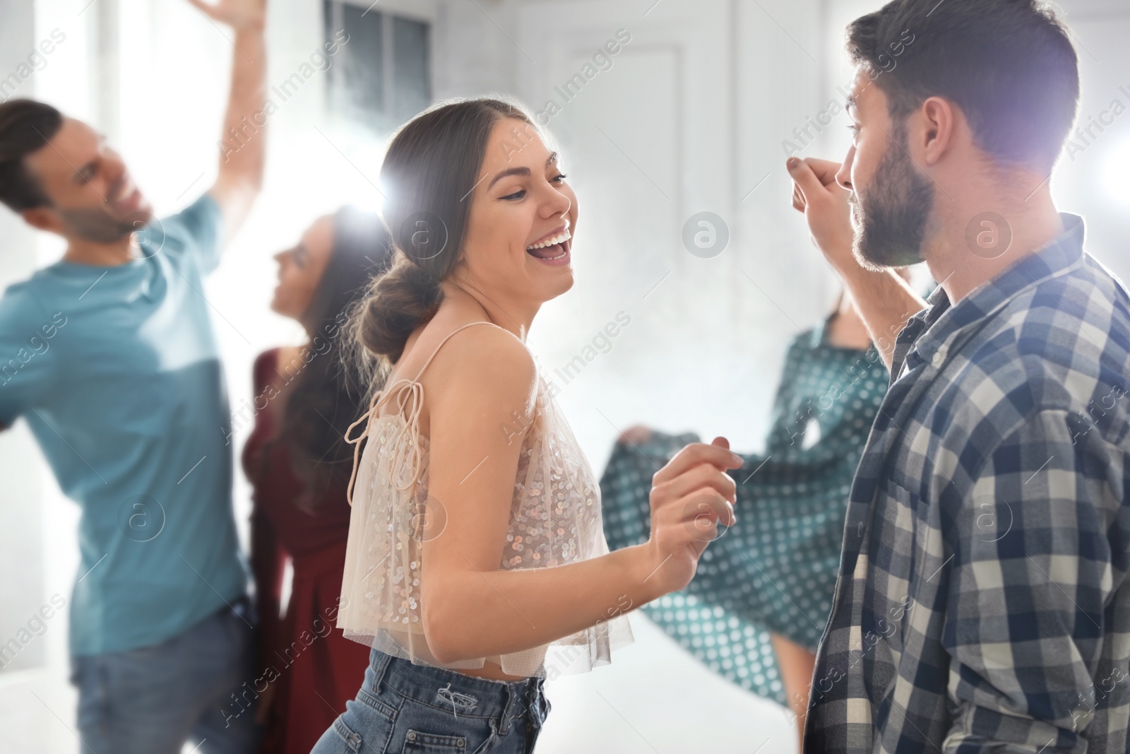 Photo of Lovely young couple dancing together at party