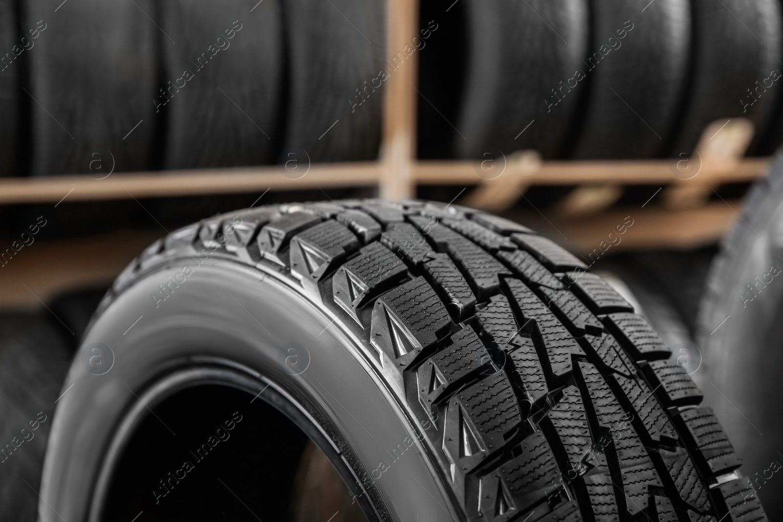 Photo of Car tire in automobile service center, closeup