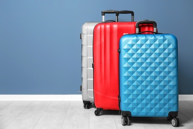Photo of Different suitcases near color wall