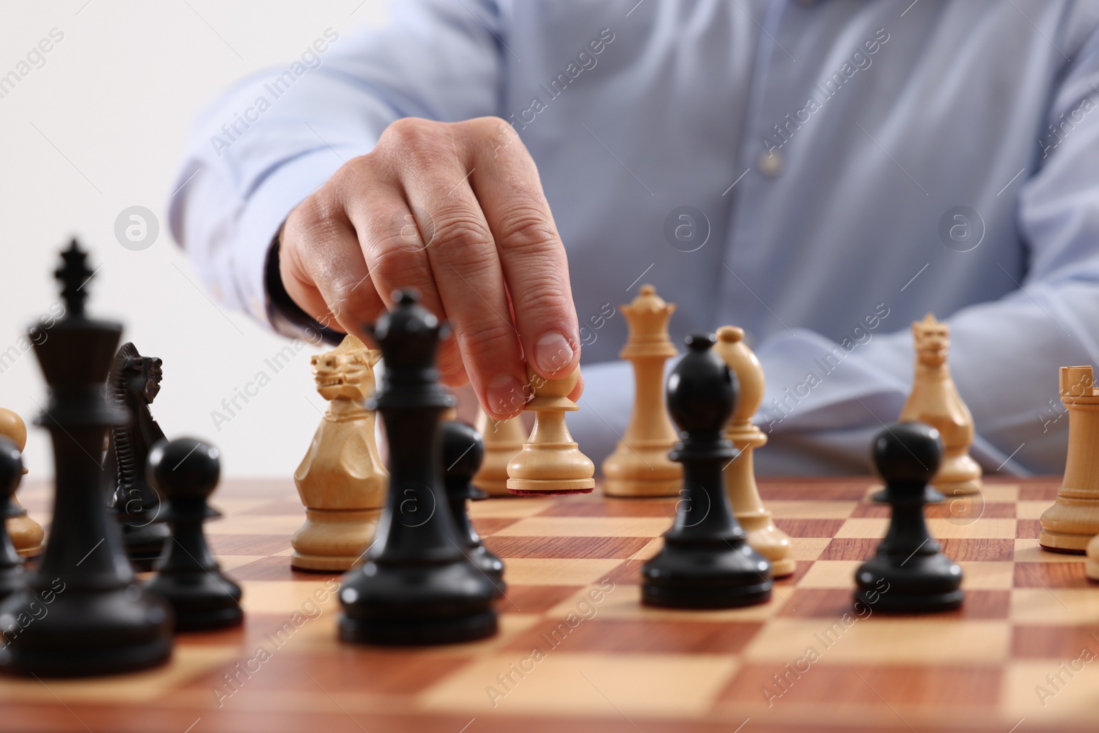 Photo of Man playing chess during tournament at chessboard, closeup