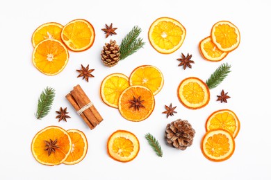 Photo of Flat lay composition with dry orange slices, anise stars, cinnamon sticks and fir cones on white background