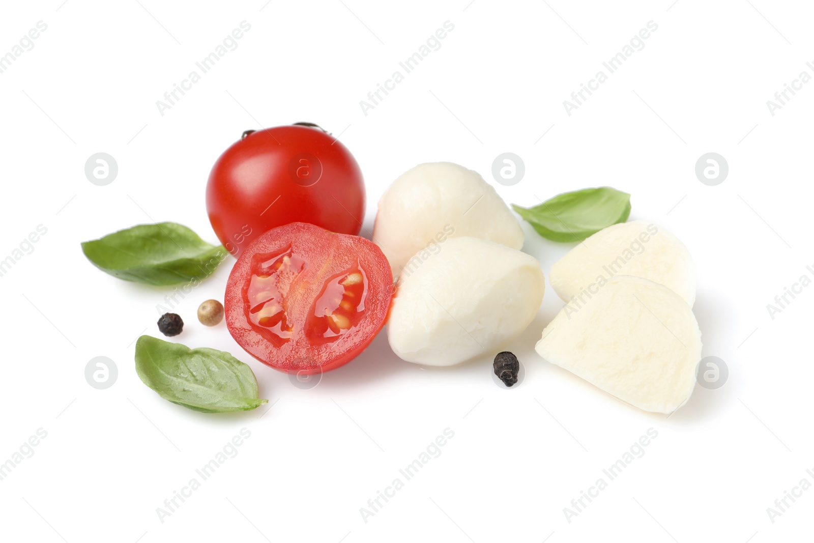 Photo of Delicious mozzarella with tomatoes and basil leaves on white background