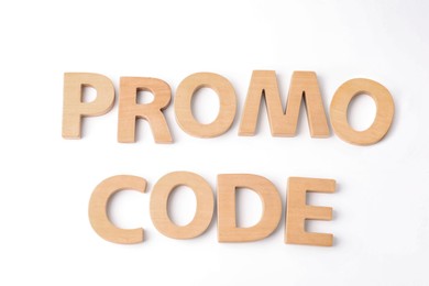 Photo of Words Promo Code made of wooden letters on white background, top view