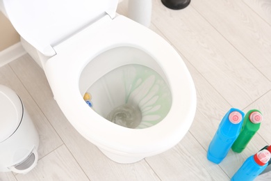 Ceramic toilet bowl with detergent in modern bathroom