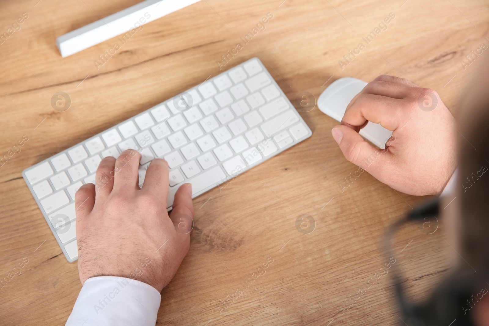 Photo of Male technical support operator working in office, closeup of hands