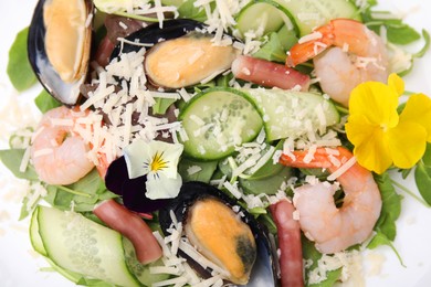 Plate of delicious salad with seafood, top view