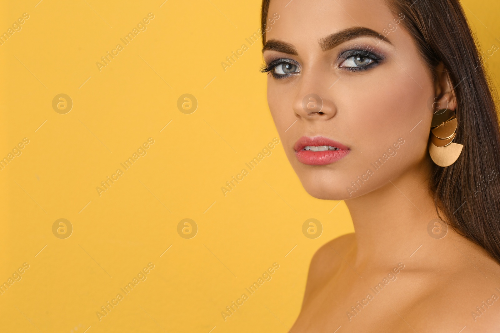 Photo of Portrait of beautiful woman with stylish makeup on color background. Space for text