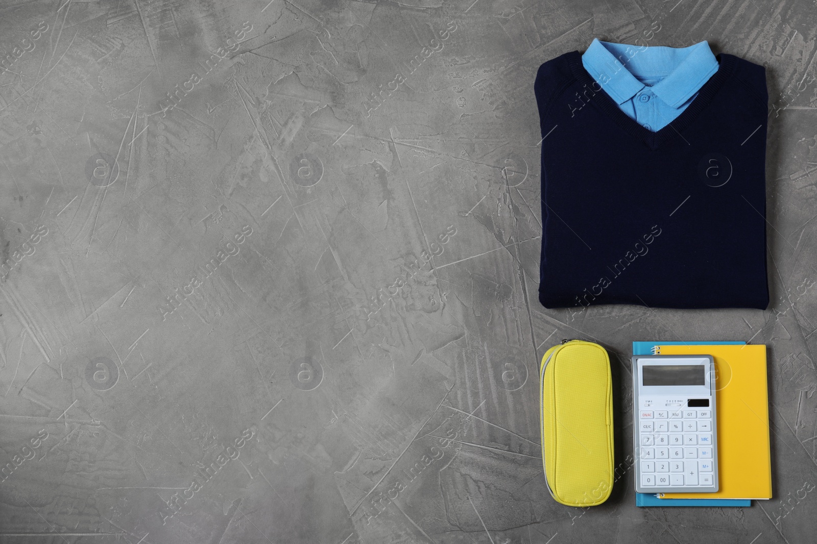 Photo of Flat lay composition with school uniform on grey background. Space for text