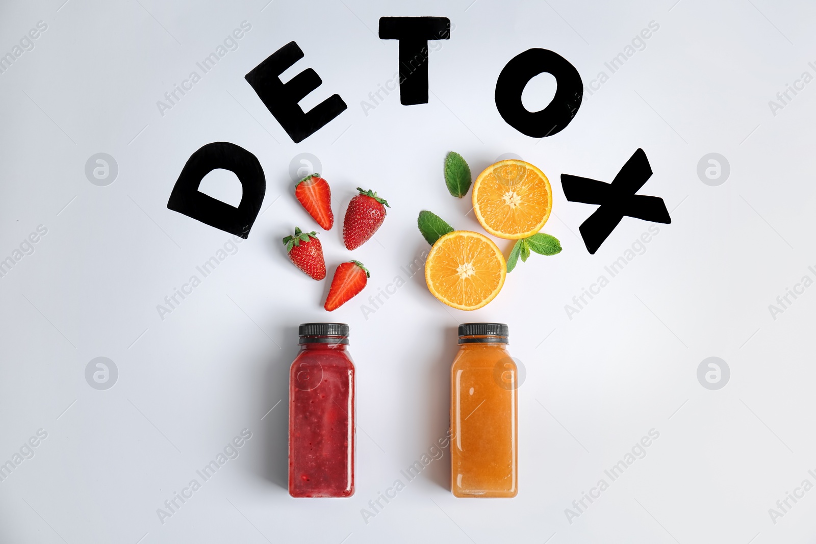 Photo of Flat lay composition with word DETOX, healthy smoothies and ingredients on light background