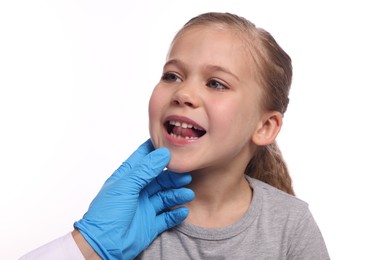Doctor examining girl`s oral cavity on white background