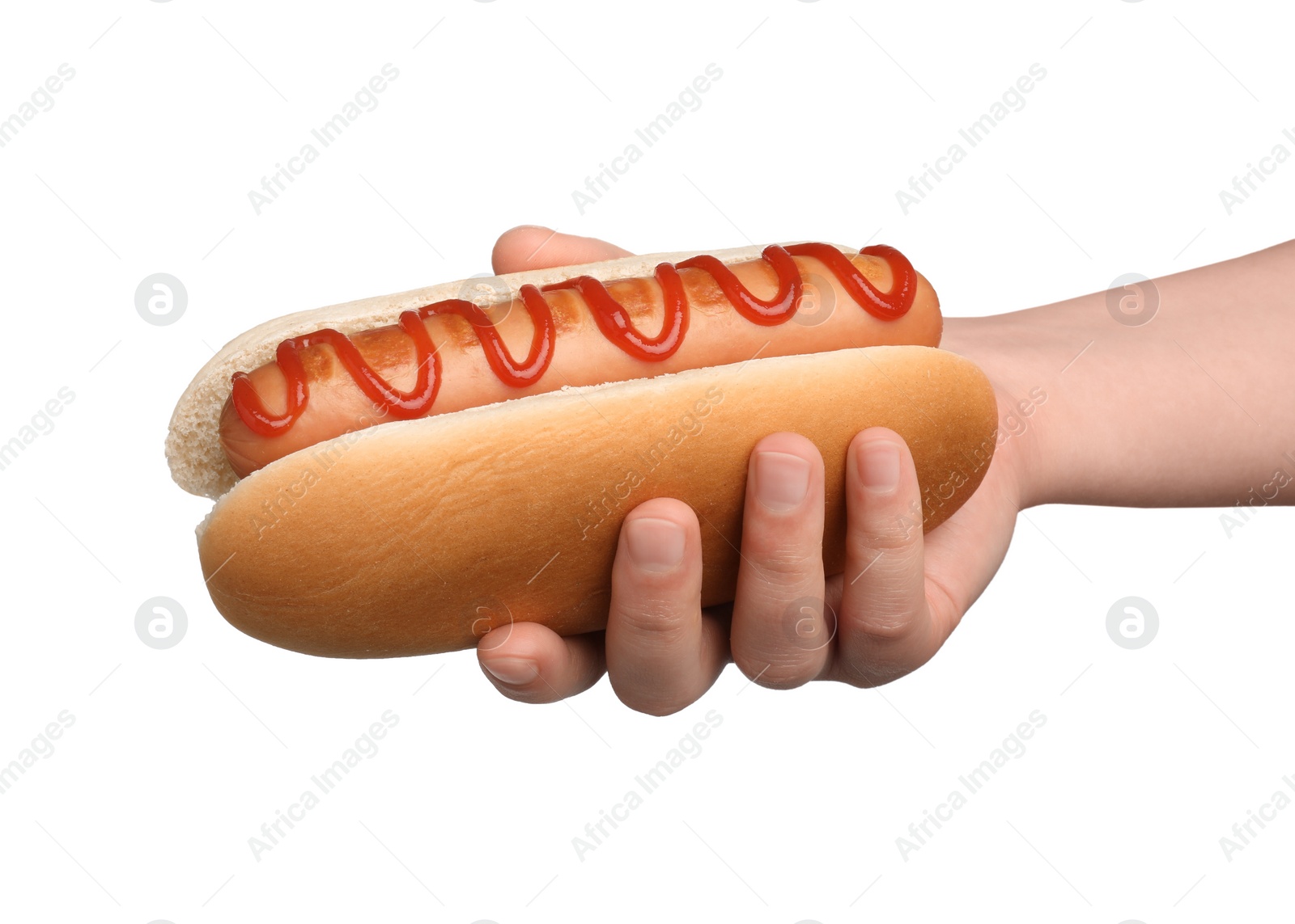 Photo of Woman holding delicious hot dog with ketchup on white background, closeup