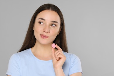 Photo of Woman with bubble gum on grey background