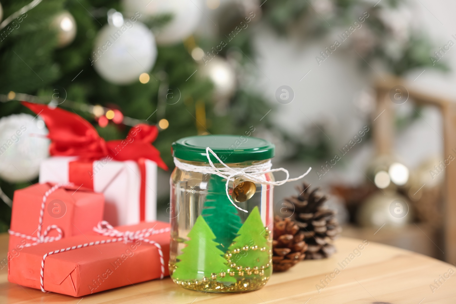 Photo of Handmade snow globe and Christmas decorations on wooden table