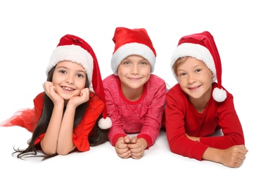 Cute little children in Santa hats on white background. Christmas celebration