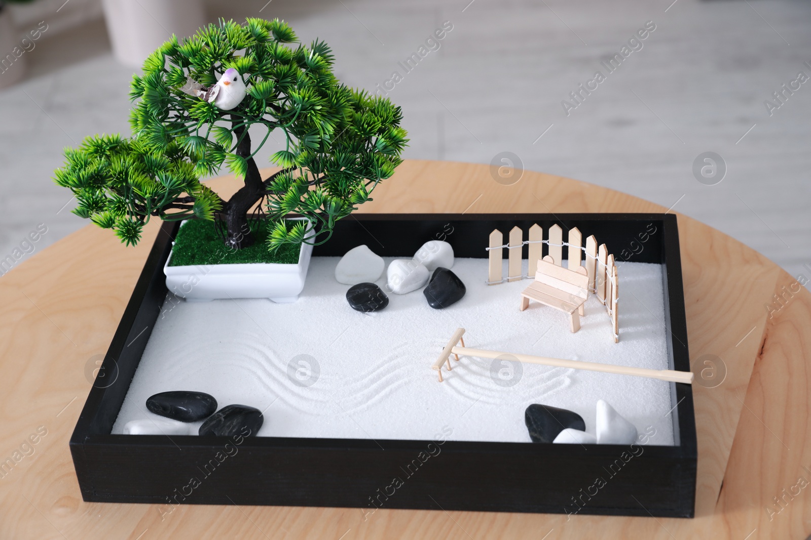 Photo of Beautiful miniature zen garden on wooden table indoors