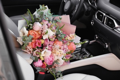 Photo of Beautiful flower bouquet inside car. Romantic surprise