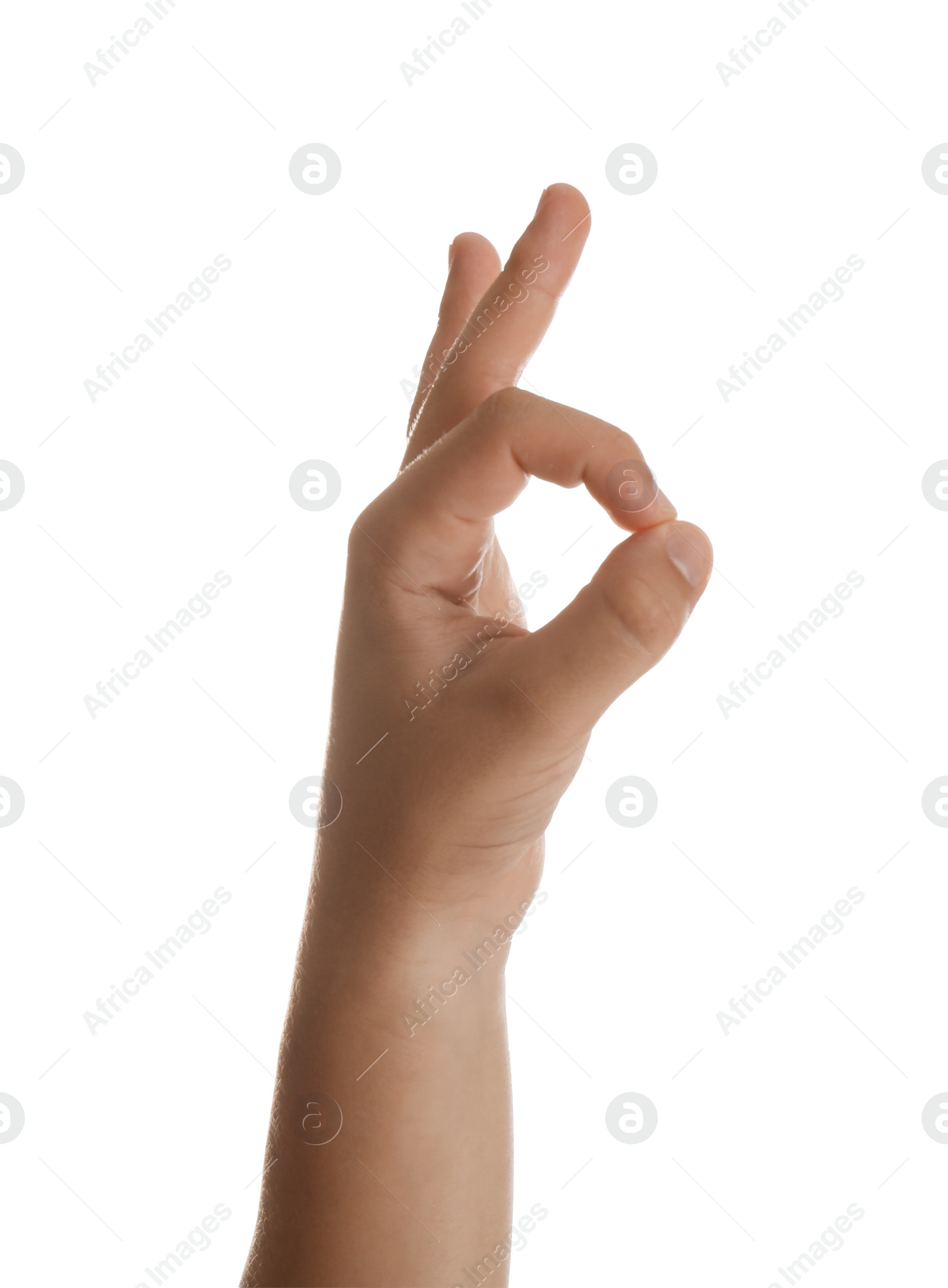 Photo of Teenage boy showing ok gesture on white background, closeup