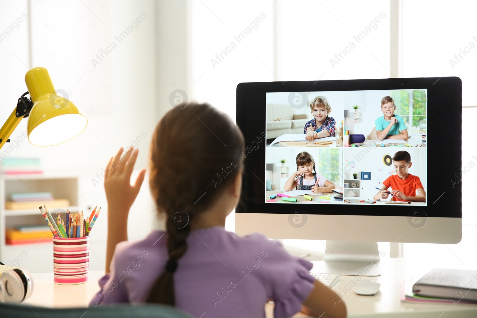 Photo of Distance learning during quarantine and lockdown due to Covid-19 pandemic. Girl having online school lesson with class indoors