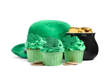 Photo of St. Patrick's day party. Tasty festively decorated cupcakes, green hat and pot of gold, isolated on white