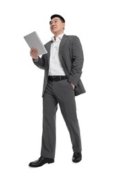 Photo of Businessman in suit with tablet on white background, low angle view