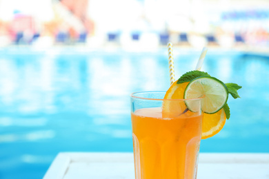 Refreshing cocktail near outdoor swimming pool on sunny day