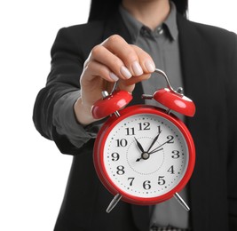 Photo of Businesswoman holding alarm clock on white background, closeup. Time management