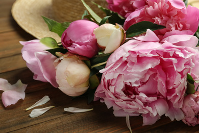 Beautiful fragrant peonies on wooden table, closeup