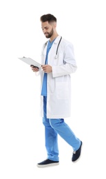 Photo of Young male doctor in uniform with clipboard isolated on white