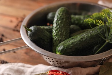 Photo of Fresh cucumbers, dill and pepper on wooden table, closeup. Pickling recipe