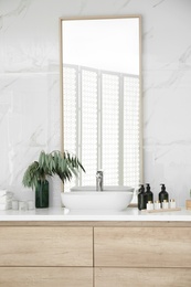 Modern bathroom interior with stylish mirror and vessel sink