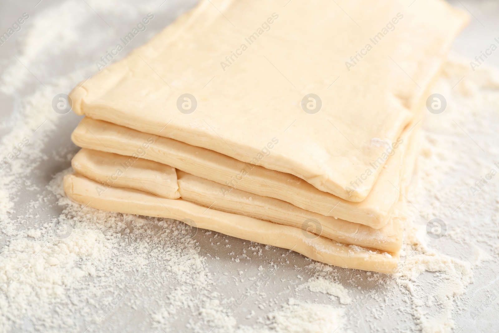 Photo of Fresh raw dough on table. Puff pastry